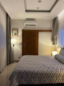 a hotel room with a bed and a window at Blue Sky Condo by Palmetto Karon in Ka Rorn +33 photos