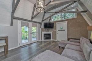 a living room with a couch and a fireplace at Secluded River Cabin Near Sly Park & Apple Hill in Placerville
