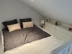 a bedroom with a large bed in a attic at Granat's Gästehouse in Höllviken