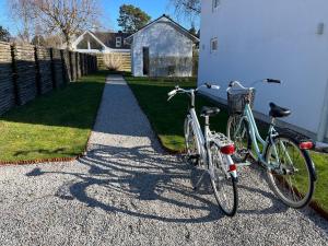 two bikes are parked next to a house at Granat's Gästehouse in Höllviken