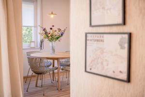 a dining room with a table with a vase of flowers at Wald & Weg in Schmallenberg +36 photos