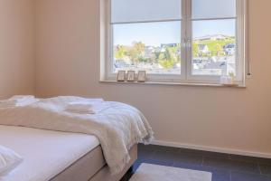 a bedroom with a bed and a window at Wald & Weg in Schmallenberg