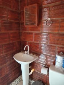 a bathroom with a sink and a toilet at Kitnet Rústica! in Januária +7 photos