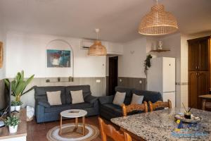 a living room with a couch and a table at El Velero Piscina top y tranquilidad a 450m playa in San José