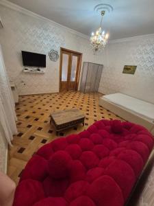 a large red ottoman in a living room at Milo Comfort 2 in Rustavi