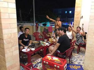 a group of people sitting around a table at Motel Tiến Phúc in Long Hai
