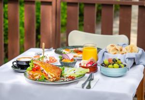 a table with plates of food and drinks on it at Beach Apartman by HelloBalatonlelle in Balatonlelle
