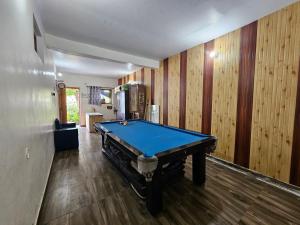 a pool table in a room with wooden walls at Saanidhya Homestay in Mukteshwar