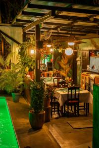 a restaurant with a table and chairs and plants at Riverside Villas in Manuel Antonio