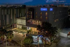 a building with a sign on the side of it at City Express by Marriott La Raza in Mexico City