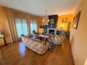 a living room with two couches and a fireplace at Chalet Can Bola in Arbeca