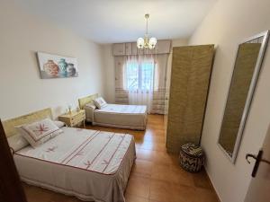 a bedroom with two beds and a couch at Chalet Can Bola in Arbeca +27 photos