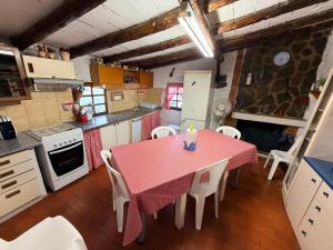 a kitchen with a pink table and white appliances at Chalet Can Bola in Arbeca
