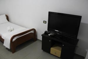 a bedroom with a flat screen tv and a bed at Casa Elefteria & Viron in Himare
