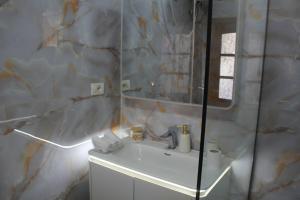 a bathroom with a sink and a mirror at Casa Elefteria & Viron in Himare +17 photos