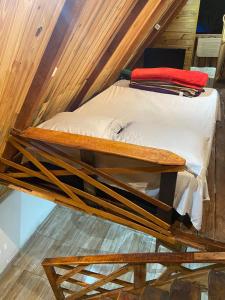 a wooden bunk bed in a room in a house at Abrigo Pedrão in Pedralva