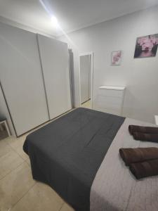 a bedroom with a large bed with a black blanket at Vinaros Modern Apartment in Vinarós