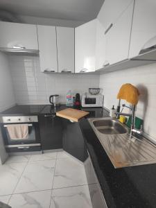 a kitchen with a sink and a stove at Vinaros Modern Apartment in Vinarós