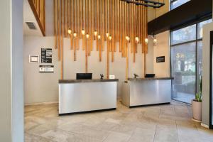 a lobby with two reception desks in a building at City Express Plus by Marriott Tampico in Tampico +88 photos