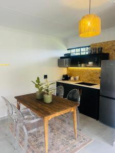 a kitchen with a wooden dining table and chairs at Origin Cottage in eMalahleni