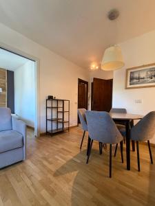 a living room with a dining room table and a couch at Le Grange Apartments - Direct Ski Access in Sauze dʼOulx