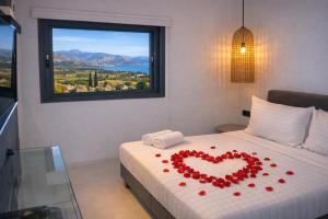 a bed with a heart made out of roses on it at Villa Irene Tolo in Tolo