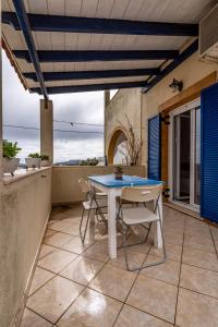 a patio with a table and chairs on a balcony at Kythaeri Studios in Frátsia