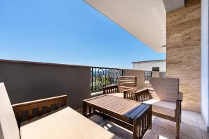 a balcony with chairs and tables on a balcony at Stars Apartments in Tivat
