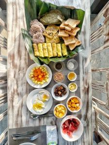a bunch of food on a table with plates of food at Ceylon Little Paradise in Hikkaduwa +24 photos