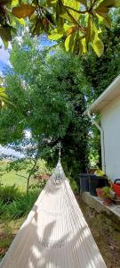 a hammock hanging from a tree in a yard at Green cabin in our small garden in Arruda dos Vinhos