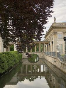 a large building with a pond in front of it at Apartament Centrum in Warsaw