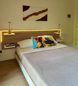 a bed with two pillows on it in a bedroom at Feel B&B and more in Saluzzo