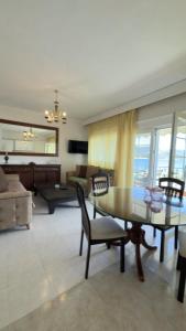 a living room with a table and chairs at Sunrise Horizon in Iraklitsa