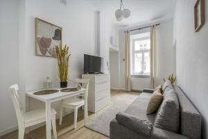 a living room with a couch and a table and a tv at Apartament Centrum in Warsaw