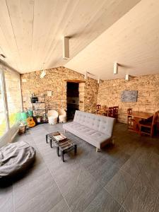 a living room with a couch and a stone wall at A casa de Carmen in Sarria