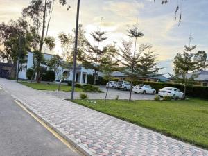 a cobblestone street with cars parked in a parking lot at Villa Serene Lusaka in Lusaka