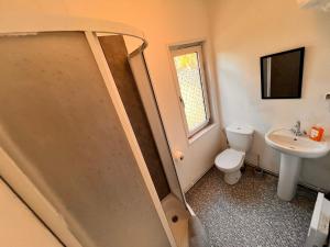a bathroom with a shower and a toilet and a sink at Domki Sosnówka-Kaszuby in Zgorzałe