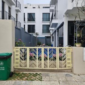 a wooden gate in front of a building at Villa Florent in Thanh Hóa