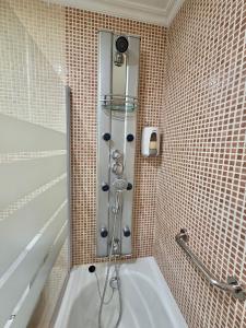 a shower in a bathroom with a tub at Playa Jardin Boiro in Boiro +14 photos