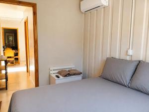 a bedroom with a bed and a hallway with a table at Condominio Vila Contanainer in Morretes