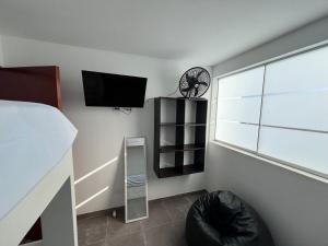 a bedroom with a bed and a clock on the wall at Los Pulpos Beach House in Bombiso