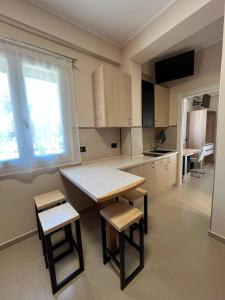a kitchen with a table and two stools and a table at B&B Bagnara Vista Mare in Bagnara Calabra