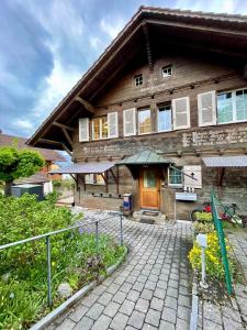 a house with a brick walkway in front of it at Mon Bijou Chalet au Lac Alpin in Thun