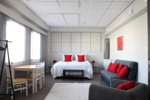 a bedroom with a bed with red pillows at Scandinavian Dream Guesthouse and Apartments in Rovaniemi