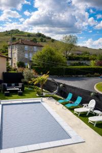a swimming pool in the yard of a house at Chez TIKA in Saint-Lager