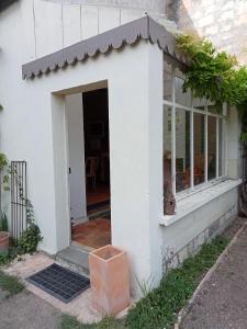 an entrance to a white house with a window at Gite du Vidame in Montsoreau +3 photos