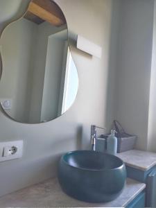 a bathroom with a blue sink and a mirror at Casina Borgo Castello in Civitella di Romagna
