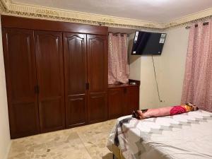 a bedroom with a bed and a flat screen tv at Segundo Piso complet in La Cuaba