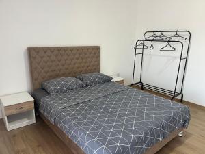 a bedroom with a bed with a blue comforter at Al Noor Villa Ilidža in Ilidža