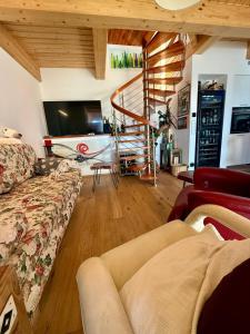 a living room with a couch and a television at Chalet am Sonnberg in Kleinlobming